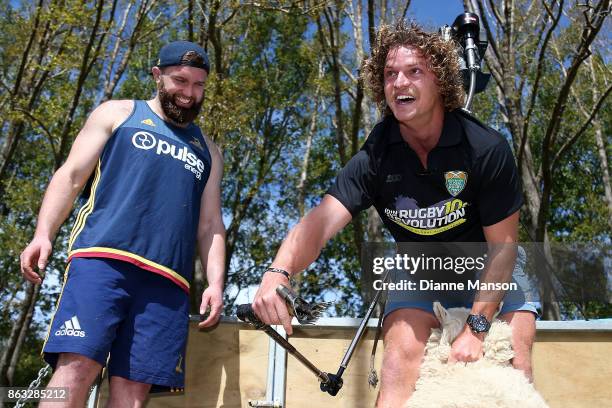 Liam Coltman of the Highlanders laughs as Nick Cummins attempts to shear a sheep in a sheep shearing contest on October 20, 2017 in Dunedin, New...