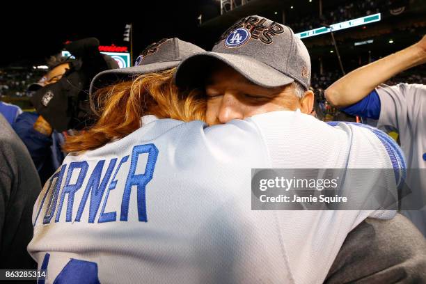 Justin Turner and manager Dave Roberts of the Los Angeles Dodgers celebrate after beating the Chicago Cubs 10-1 in game five of the National League...