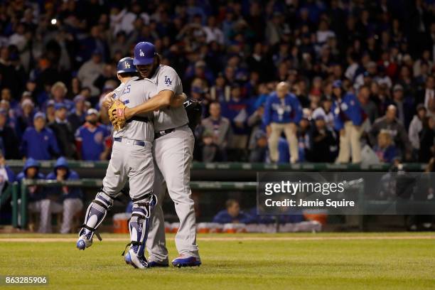 Austin Barnes and Kenley Jansen of the Los Angeles Dodgers celebrate after beating the Chicago Cubs 11-1 in game five of the National League...