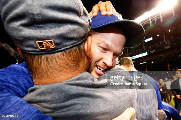Manager Dave Roberts and Clayton Kershaw of the Los Angeles Dodgers celebrate after beating the Chicago Cubs 11-1 in game five of the National League...