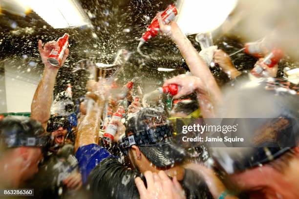 The Los Angeles Dodgers celebrate in the clubhouse after defeating the Chicago Cubs 11-1 in game five of the National League Championship Series at...