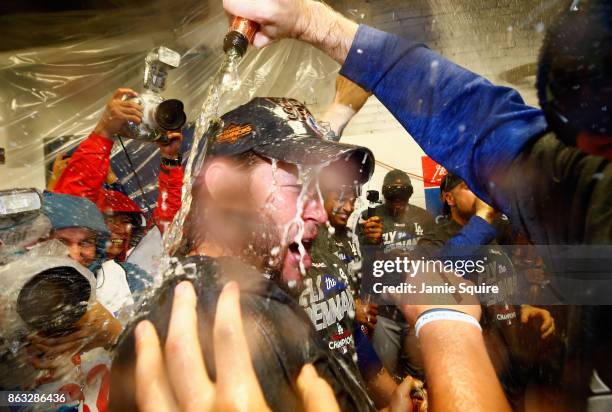 Clayton Kershaw of the Los Angeles Dodgers celebrates in the clubhouse after defeating the Chicago Cubs 11-1 in game five of the National League...