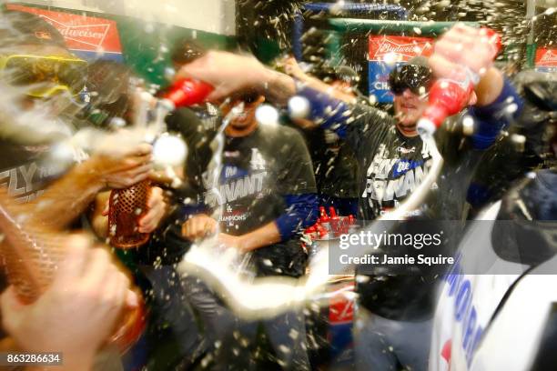 The Los Angeles Dodgers celebrate in the clubhouse after defeating the Chicago Cubs 11-1 in game five of the National League Championship Series at...