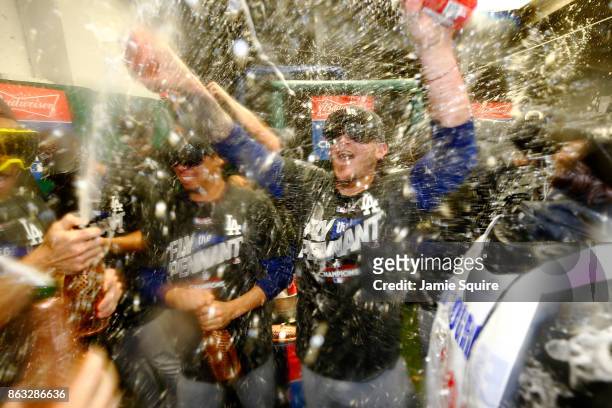 The Los Angeles Dodgers celebrate in the clubhouse after defeating the Chicago Cubs 11-1 in game five of the National League Championship Series at...