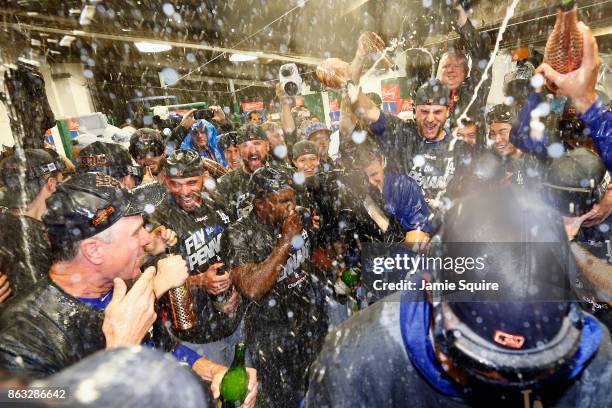 The Los Angeles Dodgers celebrate in the clubhouse after defeating the Chicago Cubs 11-1 in game five of the National League Championship Series at...