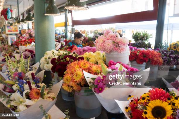 fresh flower stand at pike place market in seattle - pike place market flowers stock pictures, royalty-free photos & images