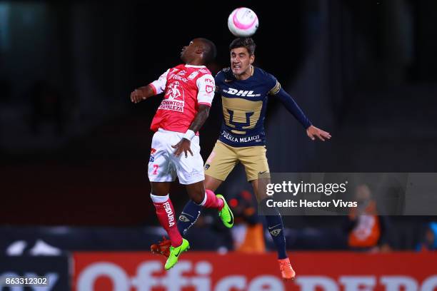 Hernan Burbano of Leon jumps for the ball with Josecarlos Van Rankin of Pumas during the 10th round match between Pumas UNAM and Leon as part of the...