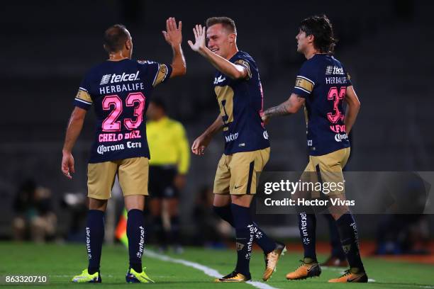 Abraham Gonzalez of Pumas celebrates with teammates after scoring the first goal of his team during the 10th round match between Pumas UNAM and Leon...