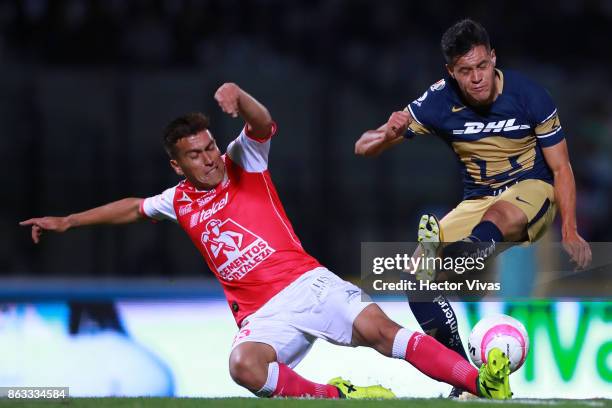 Juan Cornejo of Leon struggles for the ball with Alan Acosta of Pumas during the 10th round match between Pumas UNAM and Leon as part of the Torneo...