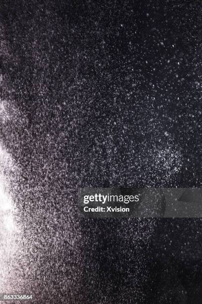 powder burst in black background - powder snow imagens e fotografias de stock