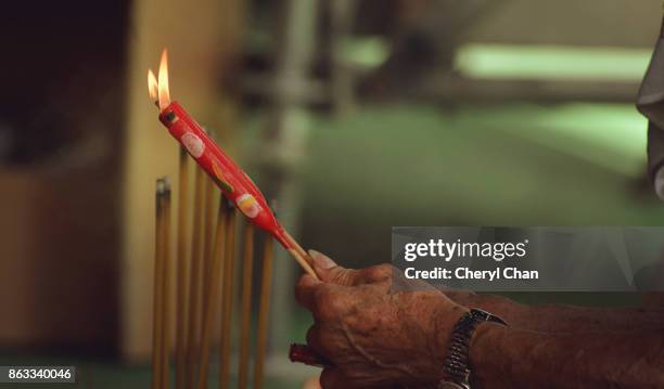 lighting chinese candles - incense stock pictures, royalty-free photos & images