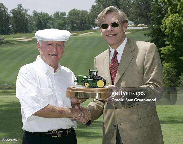 Deane Beman, left, is presented with a plaque from Bill Lane, CEO of the John Deere Company, following the Drive for a Billion ceremony at the 2005...