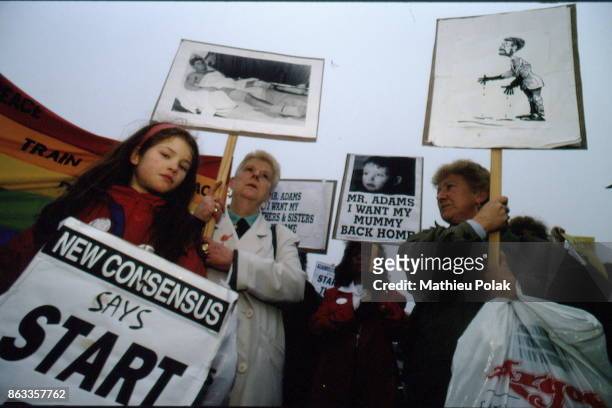 Sinn FÃ©in conference and anti-terrorism demonstration in Dublin- Demonstrators. One of them carries a placard showing a caricature of the leader of...