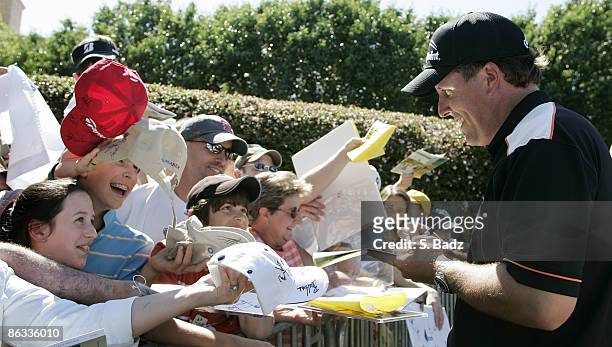 Phil Mickelson signs autographs for fans after the first round of the EDS Byron Nelson Championship on the Tournament Players Course and Cottonwood...