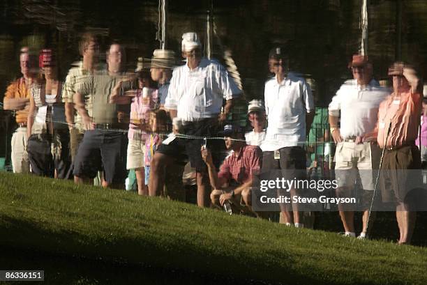 The reflection of spectators on the third fairway water is shown during the third round of the 2005 The INTERNATIONAL at Castle Pines Golf Club in...