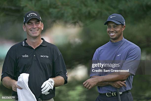 Thomas Bjorn of Denmark and Tiger Woods of the United States share a laugh during the third round of the NEC Invitational at Firestone Country Club...