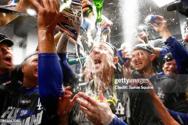 Chase Utley of the Los Angeles Dodgers celebrates in the clubhouse after defeating the Chicago Cubs 11-1 in game five of the National League...