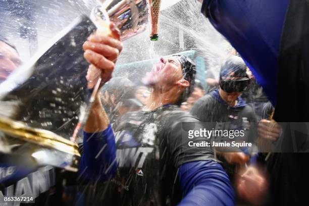 Yasmani Grandal of the Los Angeles Dodgers celebrates in the clubhouse after defeating the Chicago Cubs 11-1 in game five of the National League...