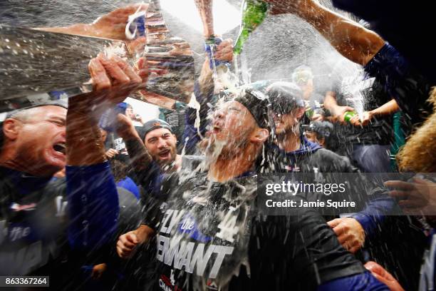 Yasmani Grandal of the Los Angeles Dodgers celebrates in the clubhouse after defeating the Chicago Cubs 11-1 in game five of the National League...