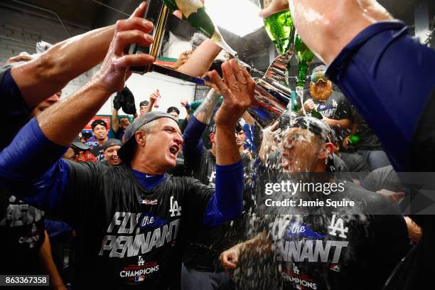 Yasmani Grandal of the Los Angeles Dodgers celebrates in the clubhouse after defeating the Chicago Cubs 11-1 in game five of the National League...