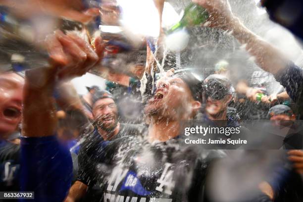 Yasmani Grandal of the Los Angeles Dodgers celebrates in the clubhouse after defeating the Chicago Cubs 11-1 in game five of the National League...