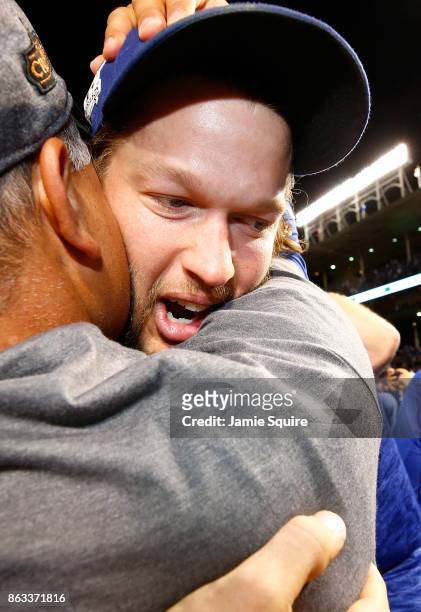 Manager Dave Roberts and Clayton Kershaw of the Los Angeles Dodgers celebrate after beating the Chicago Cubs 11-1 in game five of the National League...