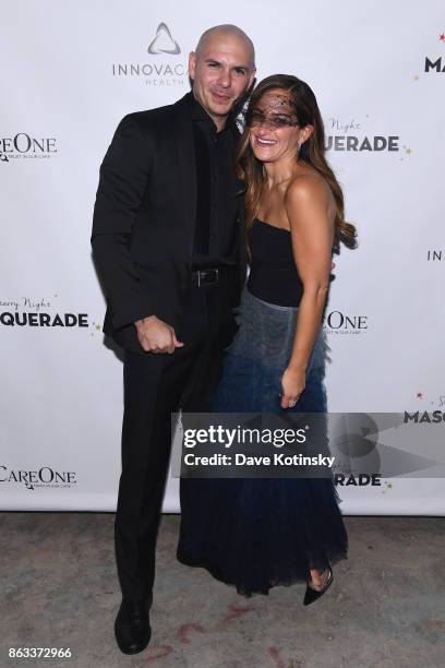 Singer Pitbull and CareOne Executive Vice President Lizzy Straus attend Daniel E Straus & CareOne Starry Night Masquerade For Puerto Ricoat Skylight...