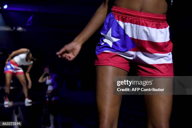 Dancers wearing the Puerto Ricn flag perform during the 2017 CareOne Masquerade Ball for Puerto Rico Relief Effort at Skylight Clarkson North on...