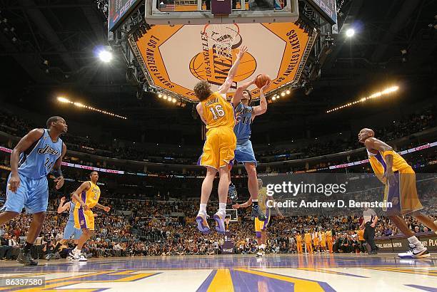 Mehmet Okur of the Utah Jazz puts up a shot against Pau Gasol of the Los Angeles Lakers in Game Five of the Western Conference Quarterfinals during...