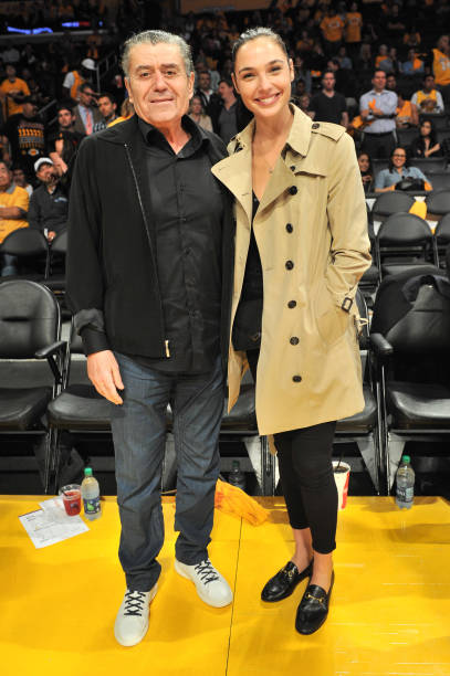 Haim Saban and actress Gal Gadot attend a basketball game between the Los Angeles Lakers and the Los Angeles Clippers at Staples Center on October...