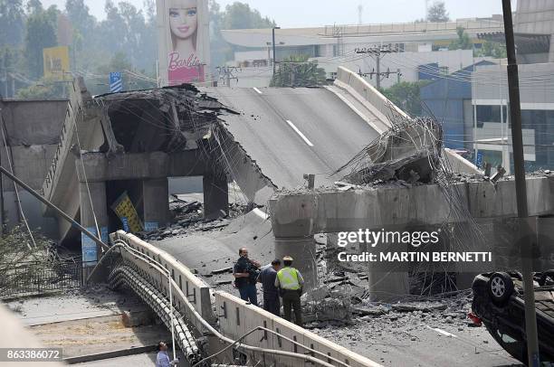 The rubble of a collpased bridge is seen in Santiago after a huge 8.8-magnitude earthquake that rocked Chile early killing at least 82 people, on...