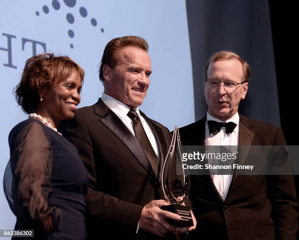 Arnold Schwarzenegger receives the 2017 Points of Light Tribute Award from Natalye Paquin, CEO of Points of Light, and board chairman, Neil Bush, at...