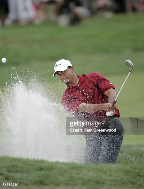 Tiger Woods of the U.S. Team hits out of a bunker during the singles matches in the final round of The Presidents Cup at Robert Trent Jones Golf Club...