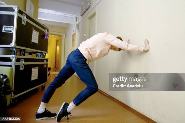 Ballerina Zhanna Gubanova warms during a rehearsal at the Russian Academic Youth Theatre in Moscow, Russia on October 20, 2017.