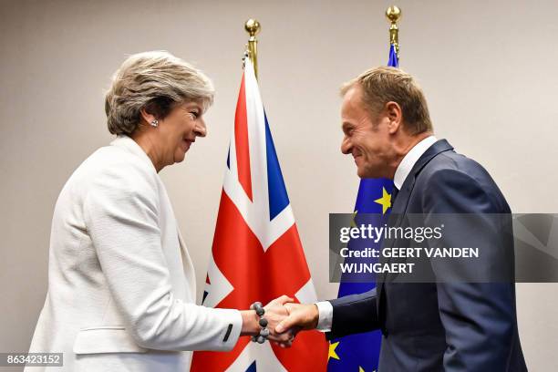 British Prime Minister Theresa May is welcomed by European Council President Donald Tusk for a bilateral meeting during an EU summit in Brussels on...