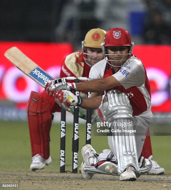 Piyush Chawla of India and the Kings XI Punjab attempts a reverse sweep shot off Anil Kumble as South African wicketkeeper Mark Boucher looks on...
