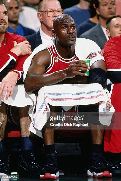 Michael Jordan of the Chicago Bulls sits on the bench wrapped in towels during Game Five of the 1997 NBA Finals played against the Utah Jazz on June...