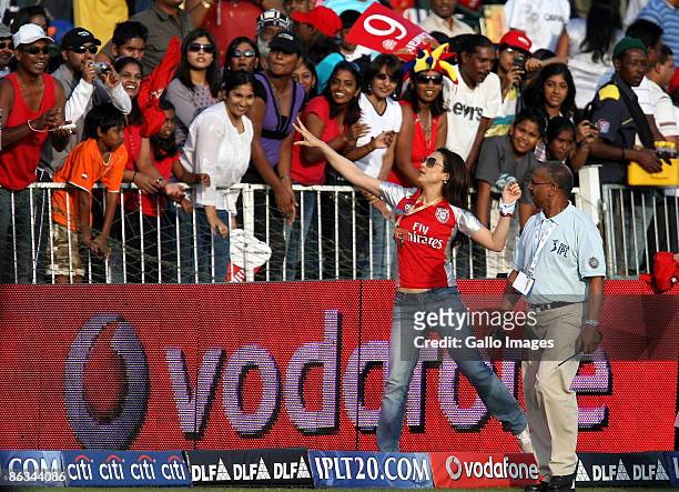 Co-owner of the Kings XI Punjab , Bollywood actress , Preity Zinta throws gifts into the crowd as SAHARA Stadium manager Clive Jaglal looks on during...