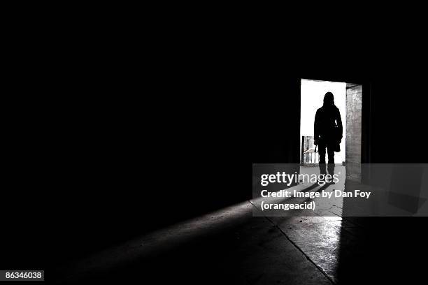 silhouette shadow of man in doorway - mystery man stock pictures, royalty-free photos & images