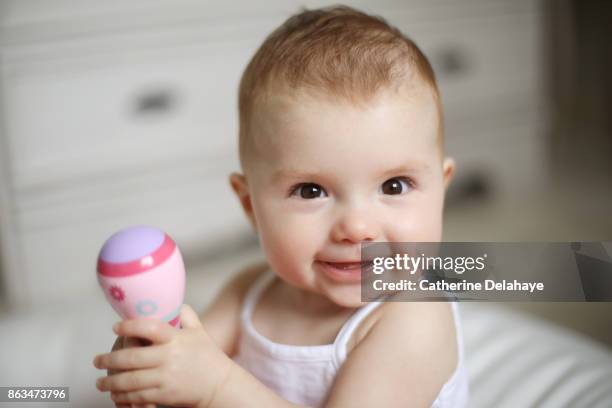 a 8 months baby girl smiling - baby girls stock pictures, royalty-free photos & images