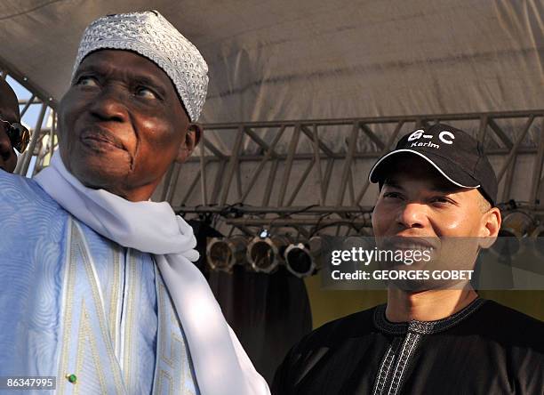 This file picture taken on March 20, 2009 shows Senegalese veteran President Abdoulaye Wade , flanked by his son Karim Wade during a meeting in...