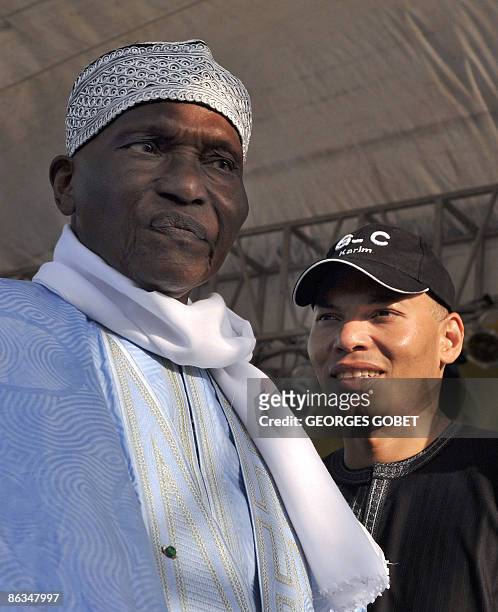This file picture taken on March 20, 2009 shows Senegalese veteran President Abdoulaye Wade , flanked by his son Karim Wade during a meeting in...