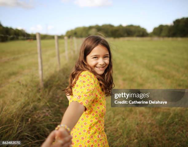 a 8 years old girl in the countryside - girl in yellow dress stock pictures, royalty-free photos & images