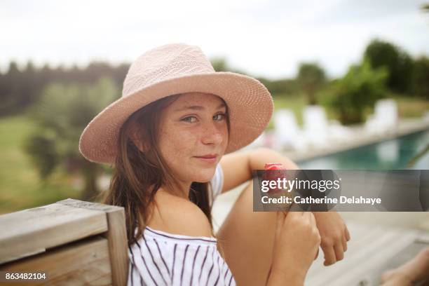 a 13 years old girl eating an icecream - 12 years old girls stock-fotos und bilder