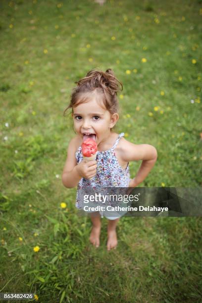 a 3 years old girl eating icecream in the garden - 2 3 years one girl only ストックフォトと画像