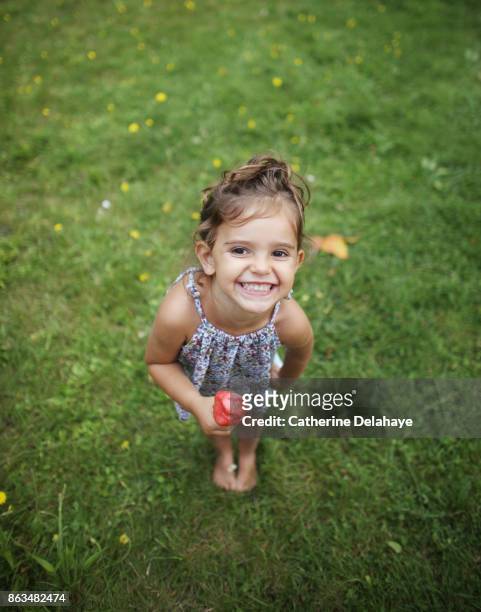 a 3 years old girl eating icecream in the garden - 2 3 years stock pictures, royalty-free photos & images