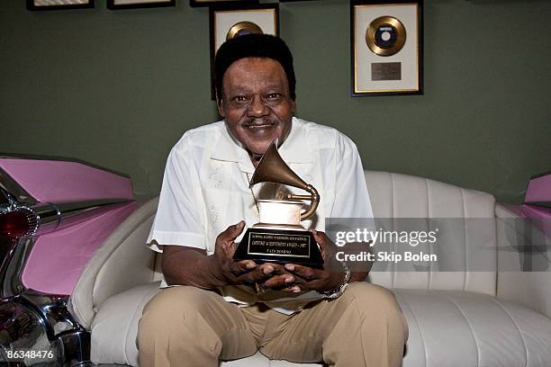 Fats Domino poses after accepting his Grammy Lifetime Achievement Award presented by the Recording Academy's Angelia Bibbs-Sanders at a ceremony to...
