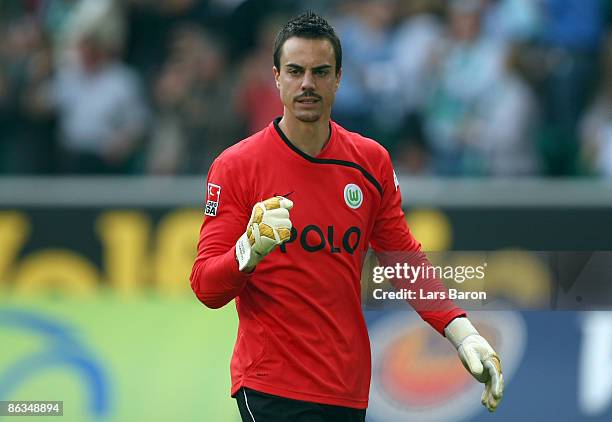 Goalkeeper Diego Benaglio of Wolfsburg celebrates after team mate Edin Dzeko scored the second goal during the Bundesliga match between VfL Wolfsburg...
