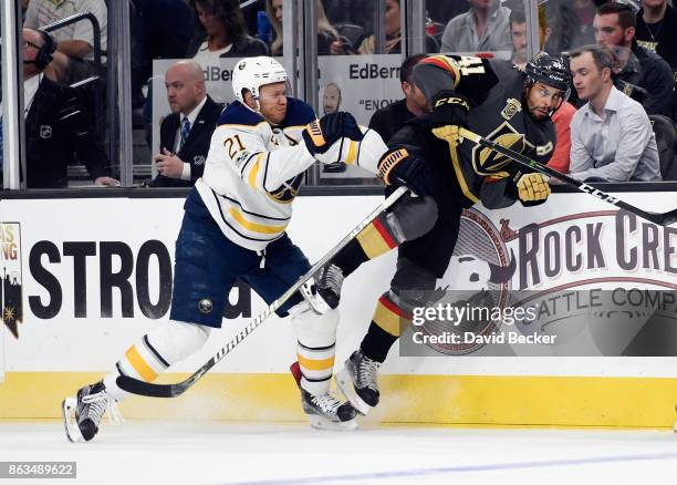 Kyle Okposo of the Buffalo Sabres checks Clayton Stoner of the Vegas Golden Knights at T-Mobile Arena on October 17, 2017 in Las Vegas, Nevada. The...