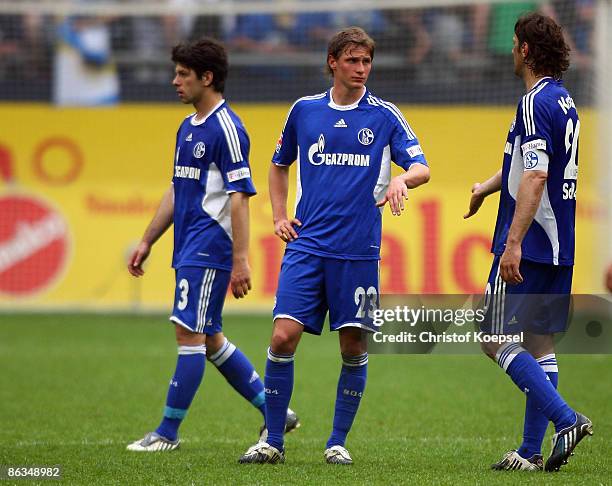 Levan Kobiashvili, Benedikt Hoewedes and Mladen Krstajic of Schalke looks dejected after losing 1-2 the Bundesliga match between Schalke 04 and Bayer...